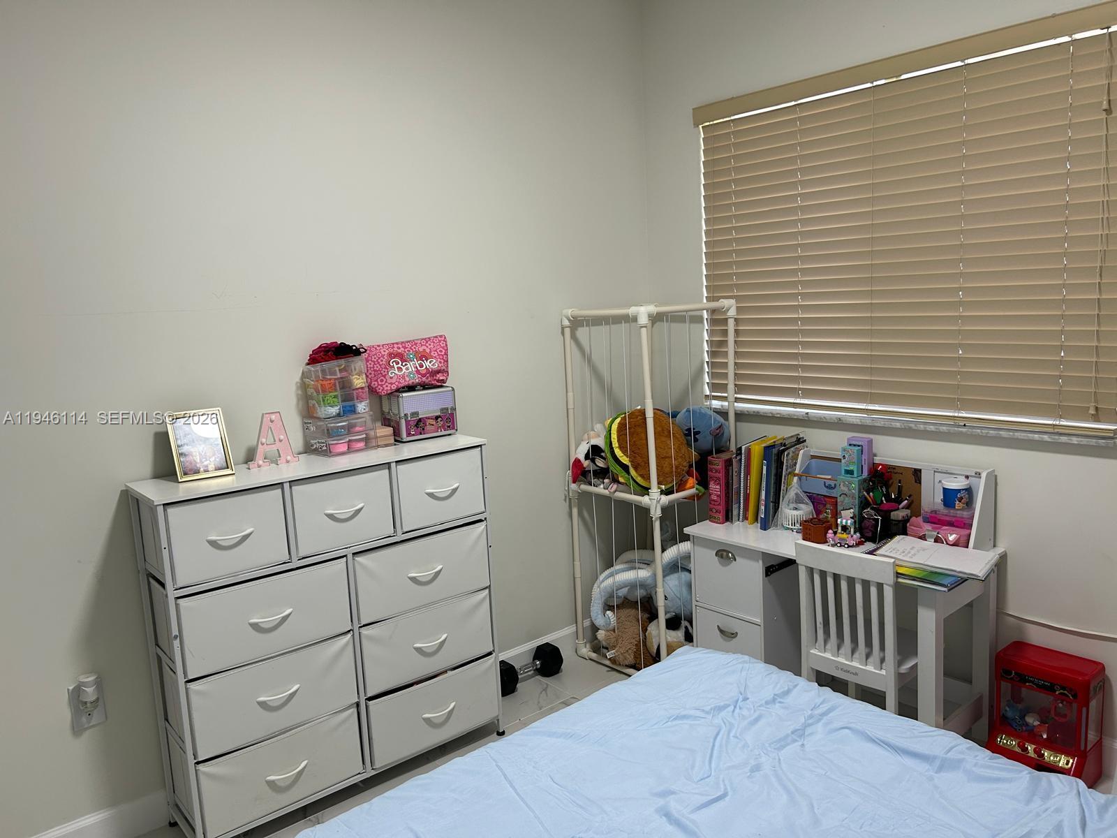 22844 Southwest 114th Avenue Miami, FL 33170 - Photo 17 of 40 a bedroom with furniture a baby crib and a window