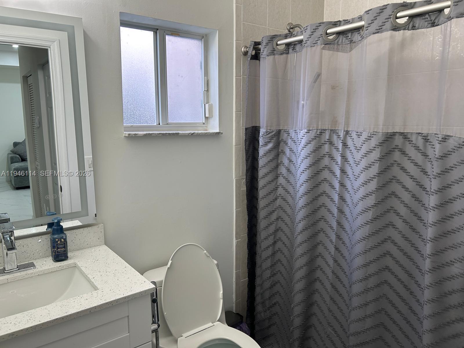 22844 Southwest 114th Avenue Miami, FL 33170 - Photo 19 of 40 a bathroom with a sink a toilet and mirror