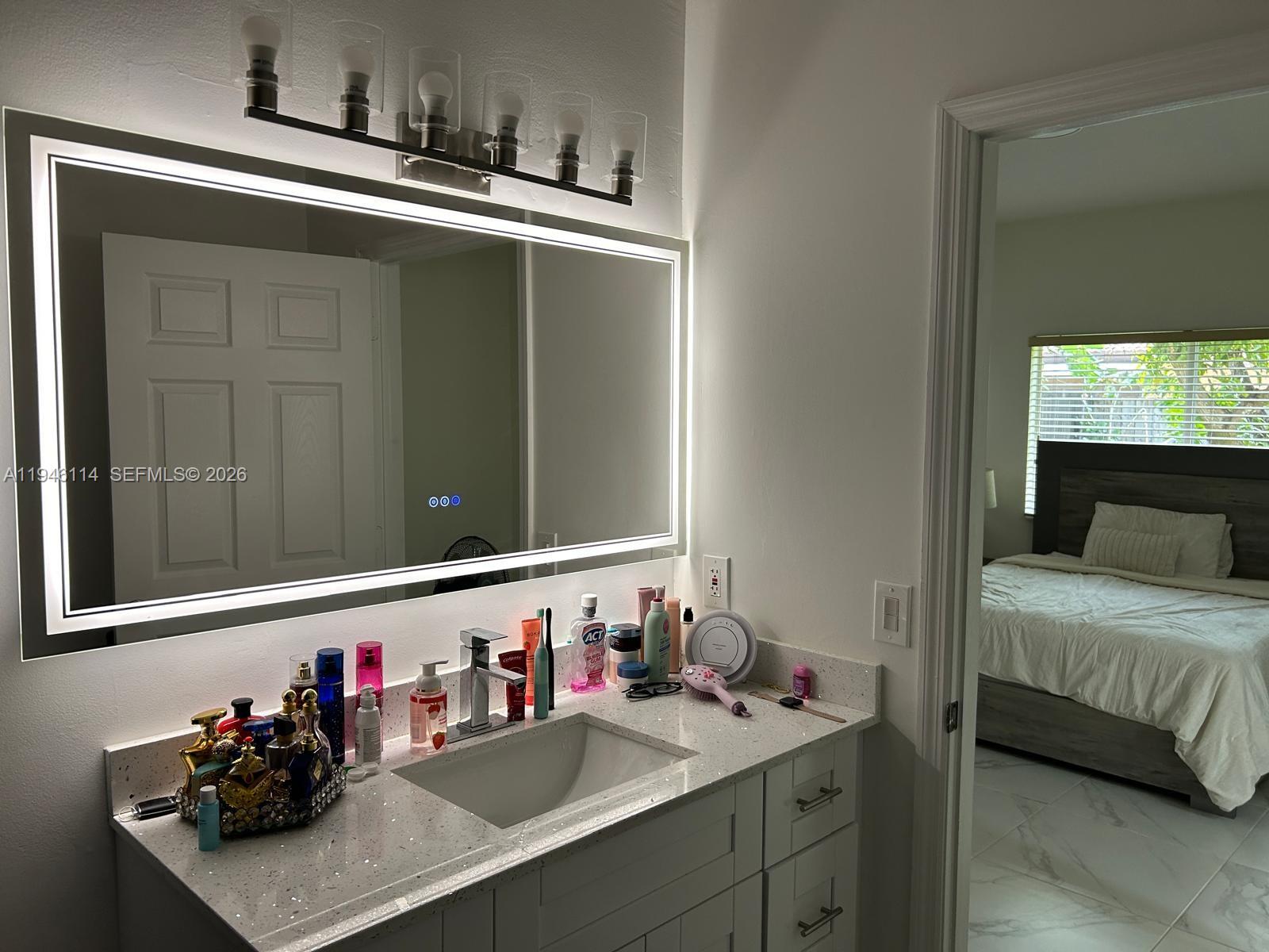 22844 Southwest 114th Avenue Miami, FL 33170 - Photo 23 of 40 a bathroom with a sink and a mirror