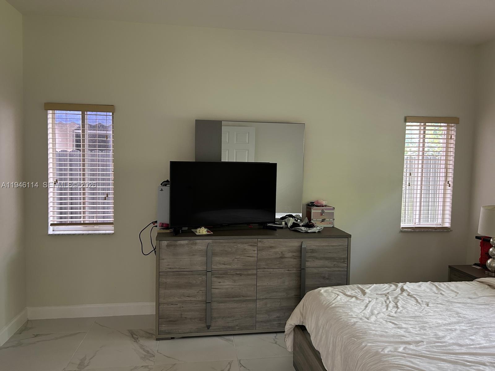 22844 Southwest 114th Avenue Miami, FL 33170 - Photo 26 of 40 a bedroom with a bed and flat screen tv