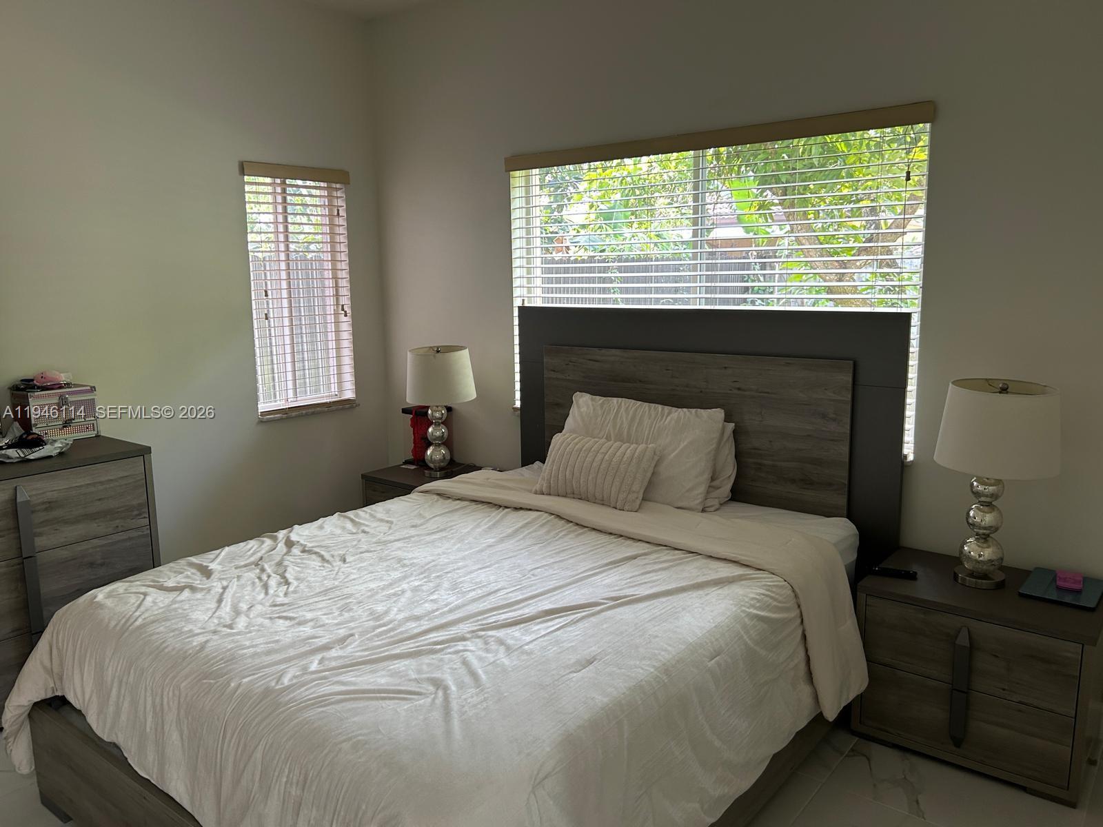 22844 Southwest 114th Avenue Miami, FL 33170 - Photo 27 of 40 a bedroom with a bed and a window