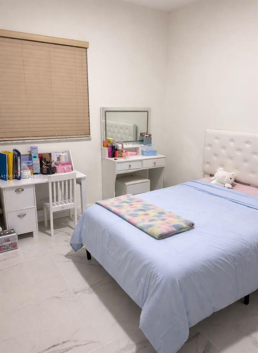 22844 Southwest 114th Avenue Miami, FL 33170 - Photo 8 of 40 a bedroom with a bed and a cabinets