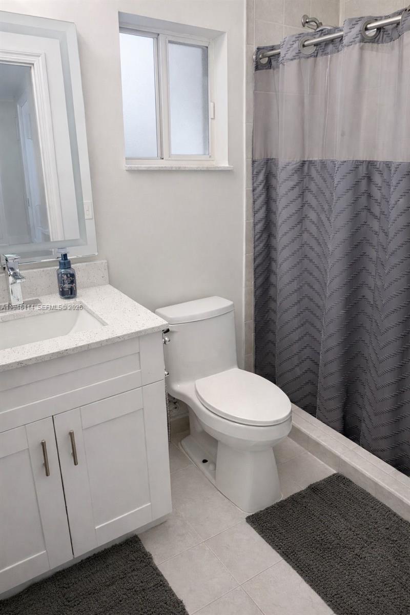 22844 Southwest 114th Avenue Miami, FL 33170 - Photo 10 of 40 a bathroom with a toilet a sink and a mirror