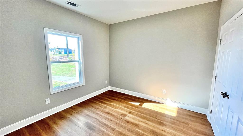 23 S Road Griffin, GA 30224 - Photo 25 of 32 an empty room with wooden floor and windows