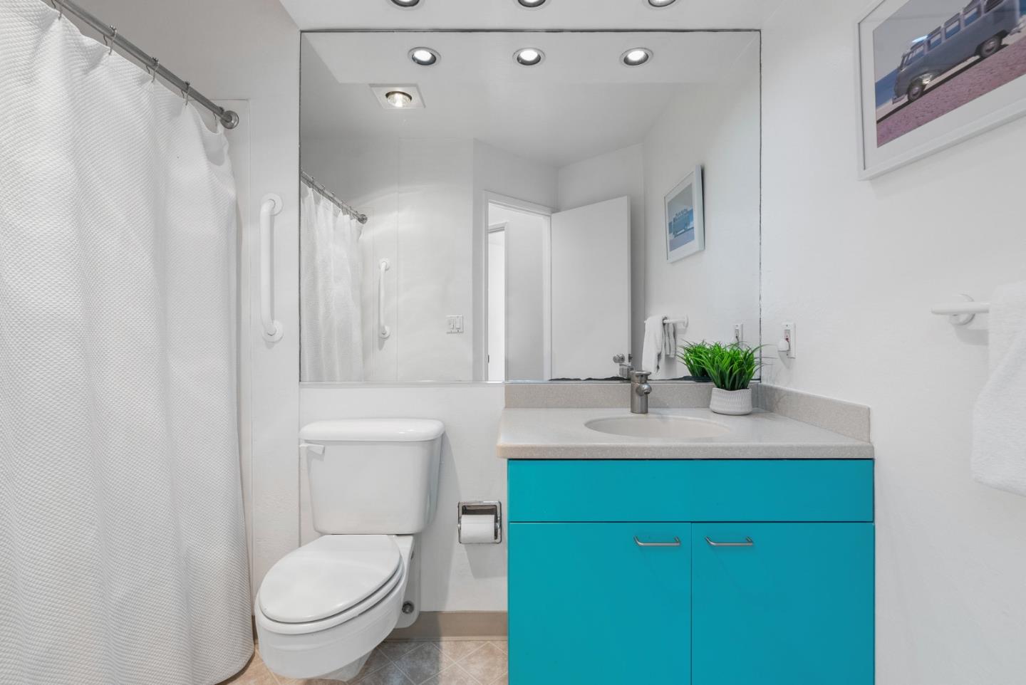 101 Shell Road, Unit 32 Watsonville, CA 95076 - Photo 24 of 44 a bathroom with a sink vanity mirror and toilet