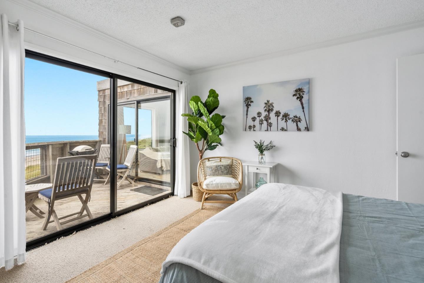 101 Shell Road, Unit 32 Watsonville, CA 95076 - Photo 30 of 44 a bedroom with a balcony a bed and a painting on the wall