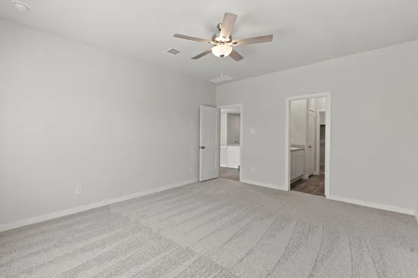 a view of an empty room with a ceiling fan