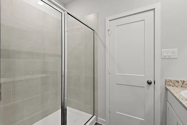 a bathroom with a glass shower door