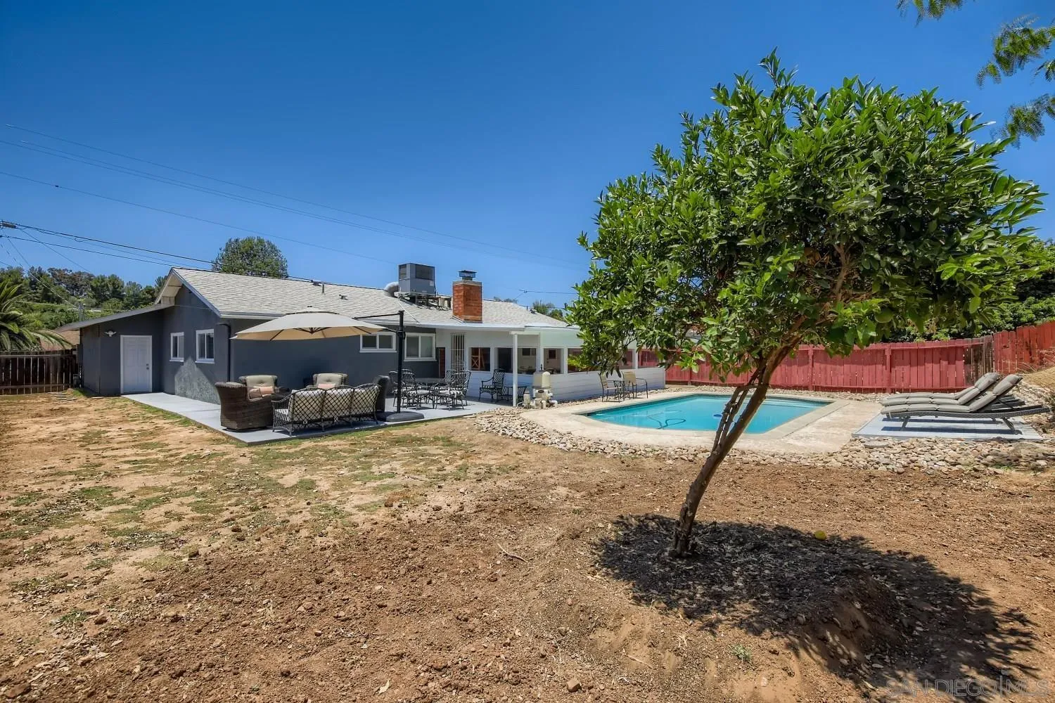 14167 Frame Road Poway, CA 92064 - Photo 24 of 27 a roof deck with a table and chairs under an umbrella