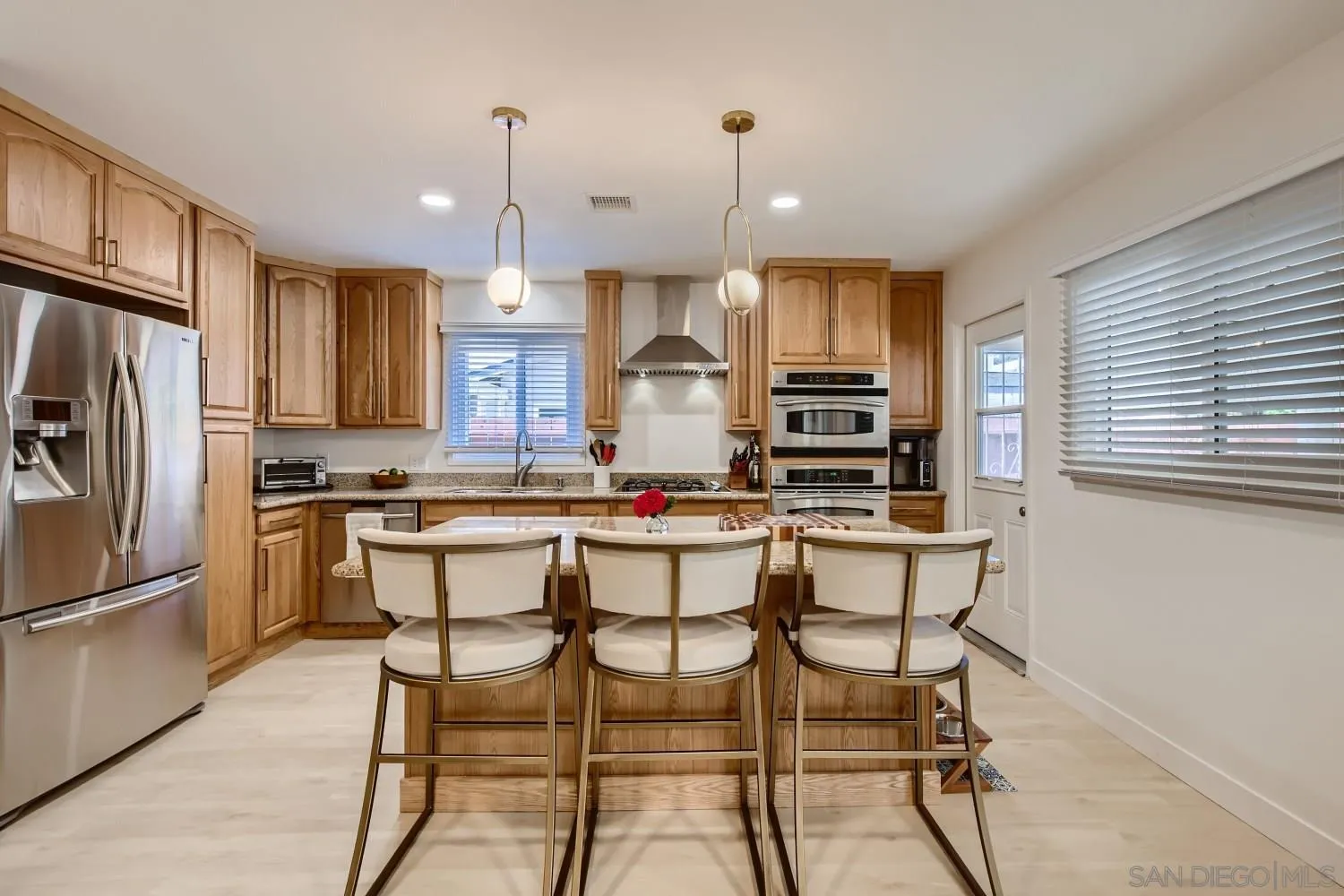 14167 Frame Road Poway, CA 92064 - Photo 9 of 27 a kitchen with granite countertop a table chairs stove microwave and cabinets