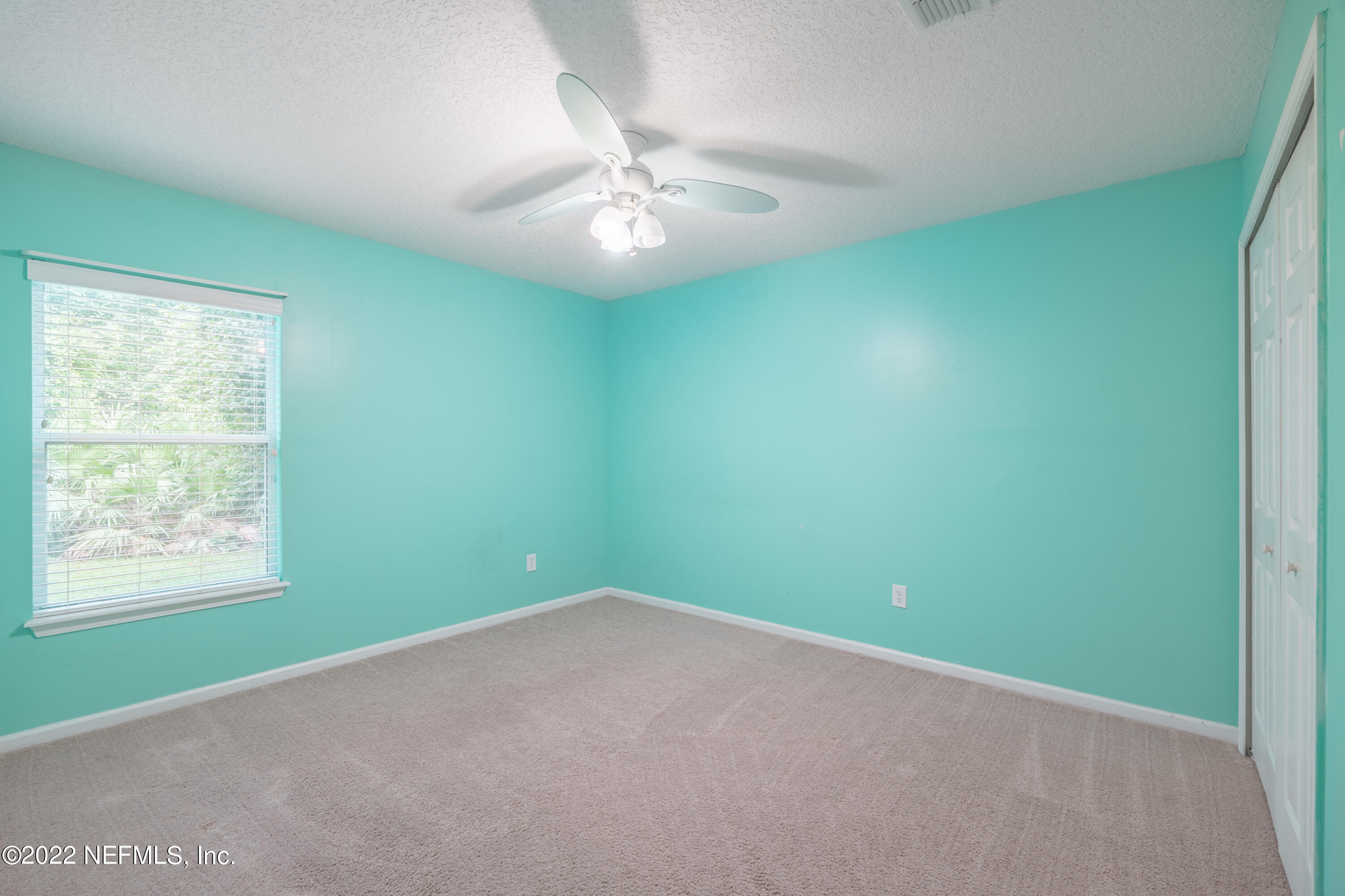 1535 Summerdown Way St. Johns, FL 32259 - Photo 19 of 38 an empty room with a window and a fan