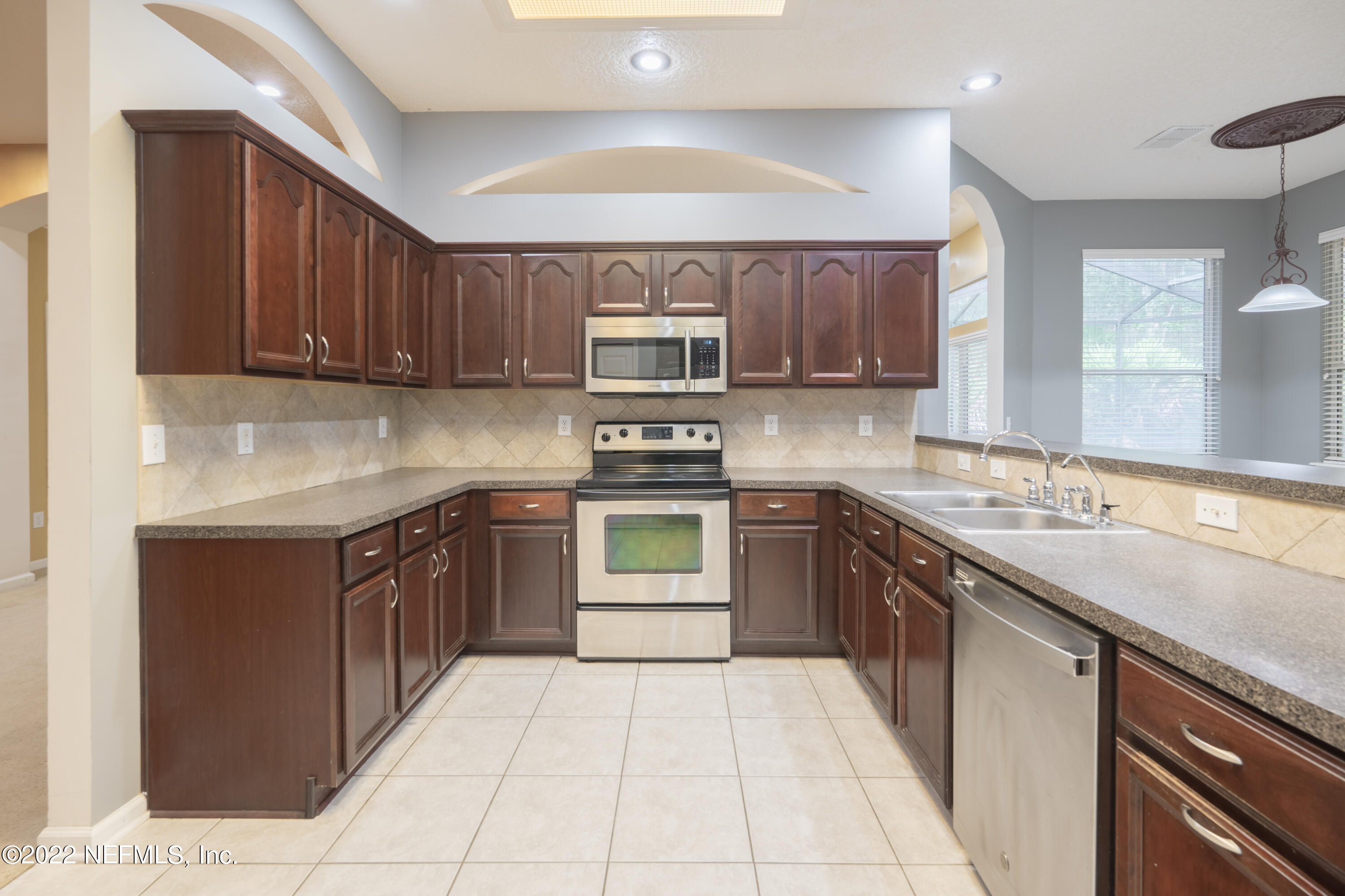 1535 Summerdown Way St. Johns, FL 32259 - Photo 24 of 38 a kitchen with a sink stove top oven and cabinets