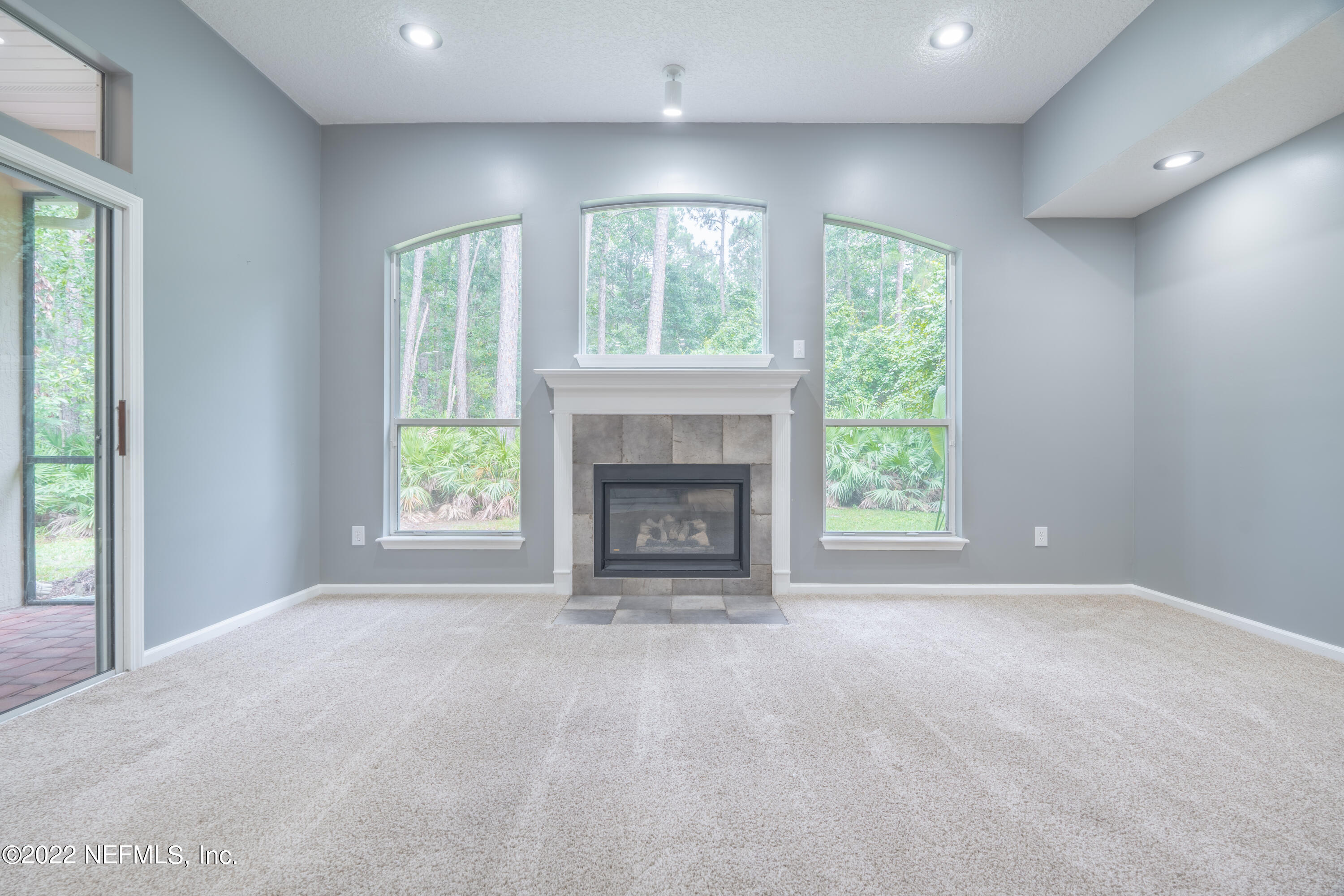 1535 Summerdown Way St. Johns, FL 32259 - Photo 28 of 38 a view of an empty room with a fireplace and a window