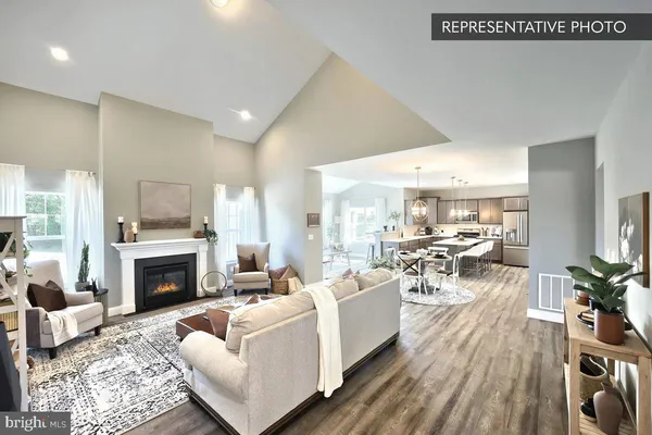 a living room with furniture a fireplace and a table
