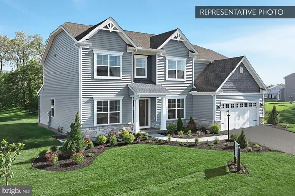 a front view of a house with a garden and yard
