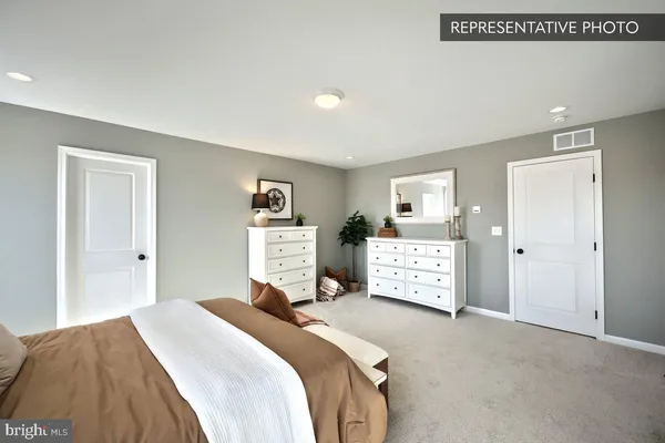 a bedroom with a bed and a cabinets