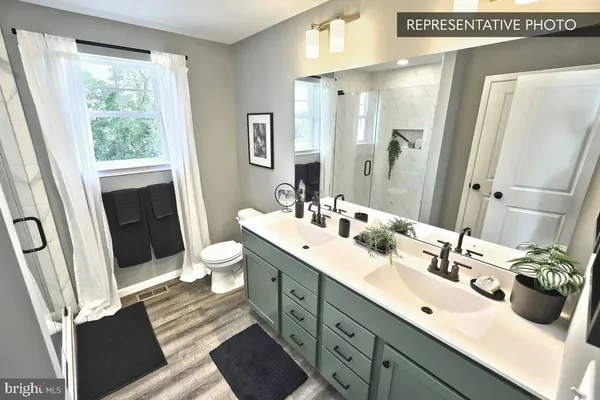 a bathroom with a double vanity sink and mirror