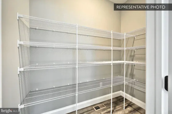 a view of walk in closet with empty racks