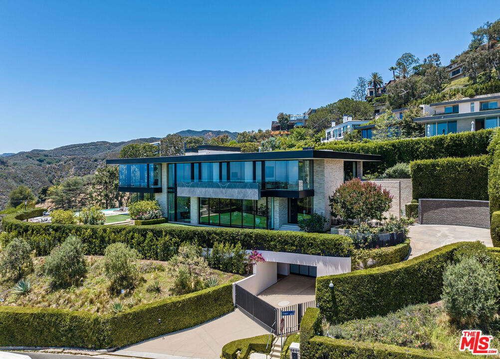 1601 Casale Road Pacific Palisades, CA 90272 - Photo 12 of 24 a view of a house with garden and a sitting area