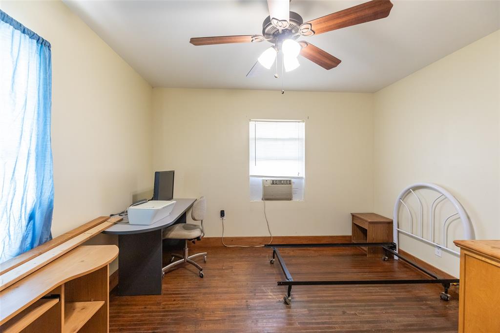 640 Ground Street Moran, TX 76464 - Photo 17 of 35 Room featuring wood-finish flooring, a ceiling fan with light fixture, and neutral painted walls