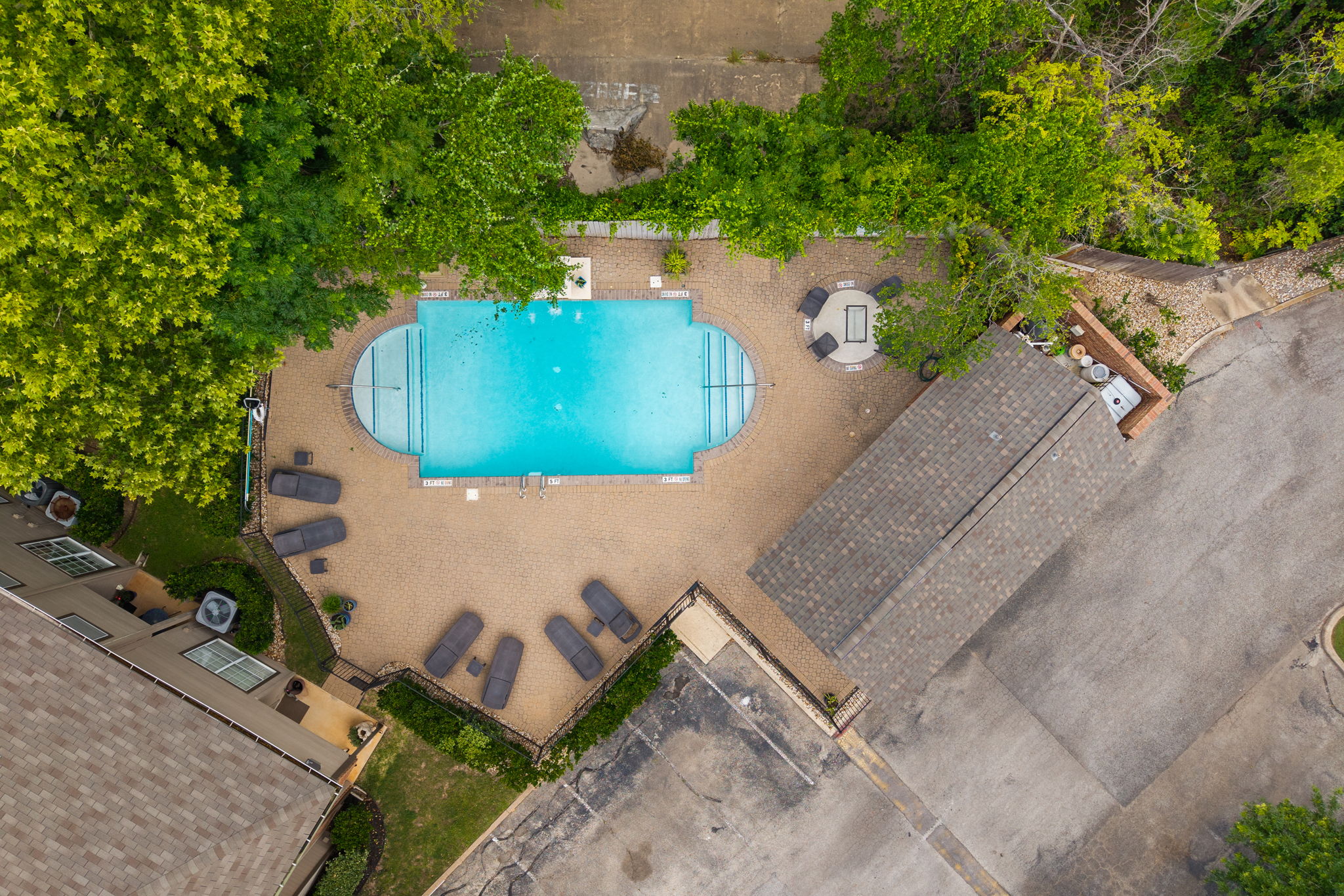 12401 Los Indios Trail, Unit 32 Austin, TX 78729 - Photo 32 of 39 An inviting community pool with ample lounge seating awaits for relaxation and recreation.