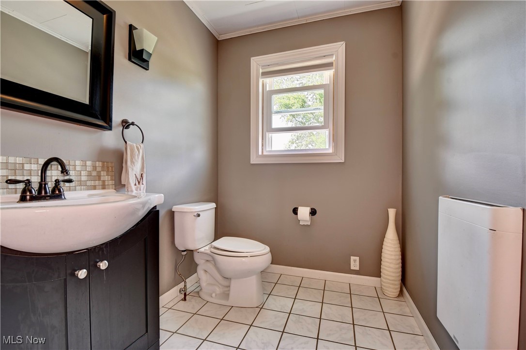 115 Buena Vista Street Baltic, OH 43804 - Photo 18 of 41 Bathroom with tasteful backsplash, toilet, tile patterned flooring, ornamental molding, and vanity