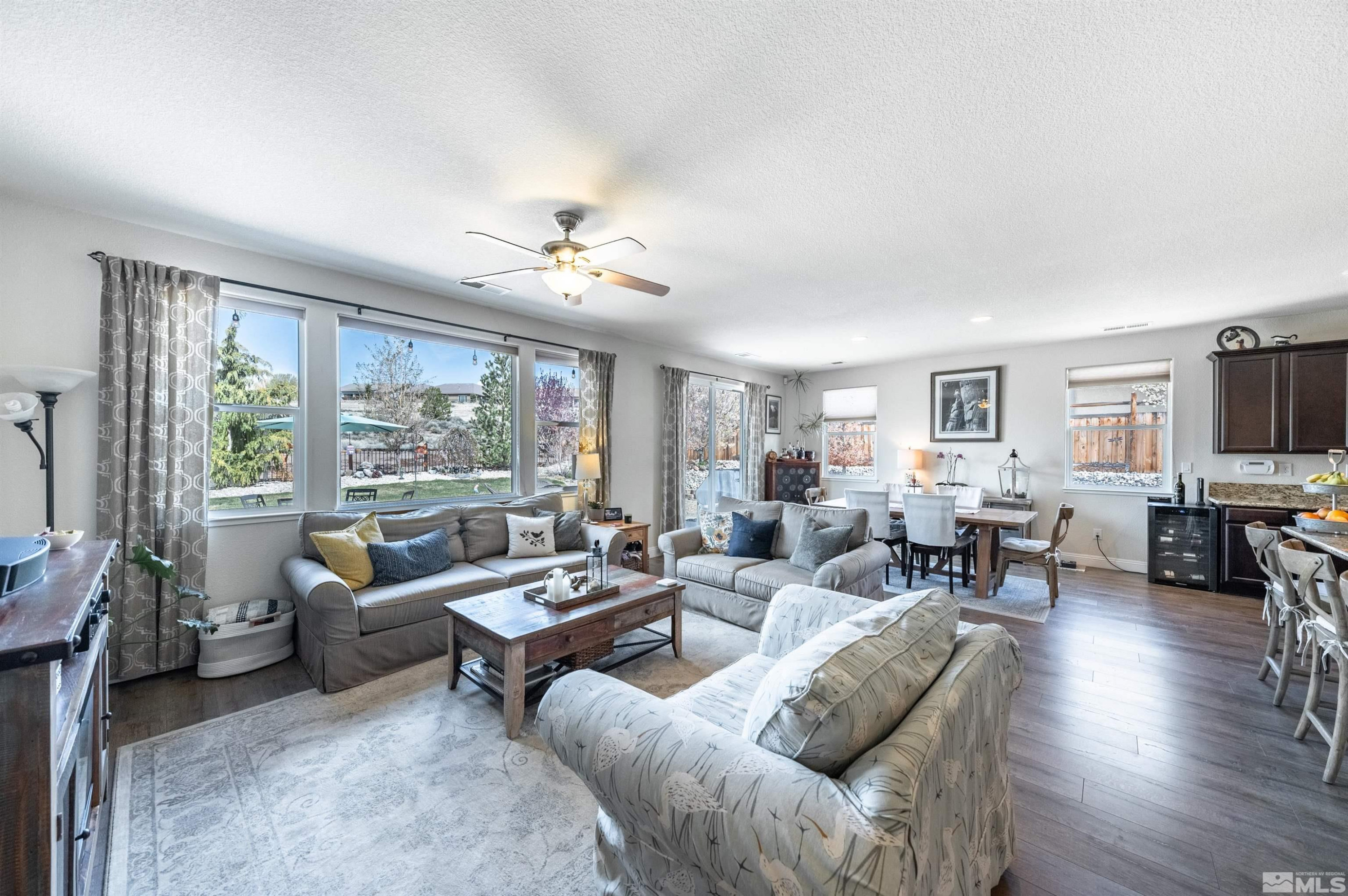7080 Truth Drive Sparks, NV 89436 - Photo 14 of 40 a living room with furniture and a flat screen tv with wooden floor