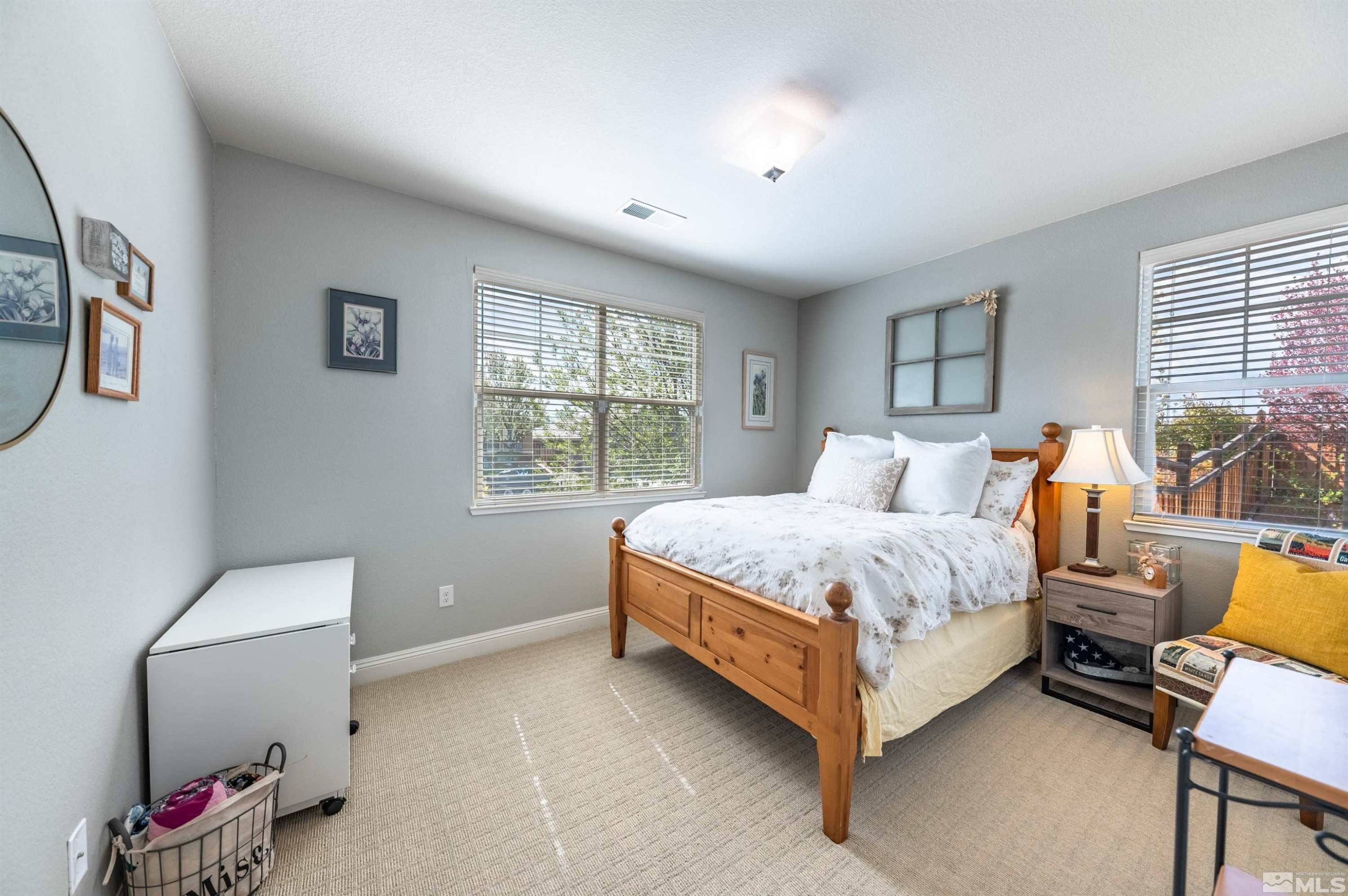 7080 Truth Drive Sparks, NV 89436 - Photo 23 of 40 a bed room with a bed and a chair