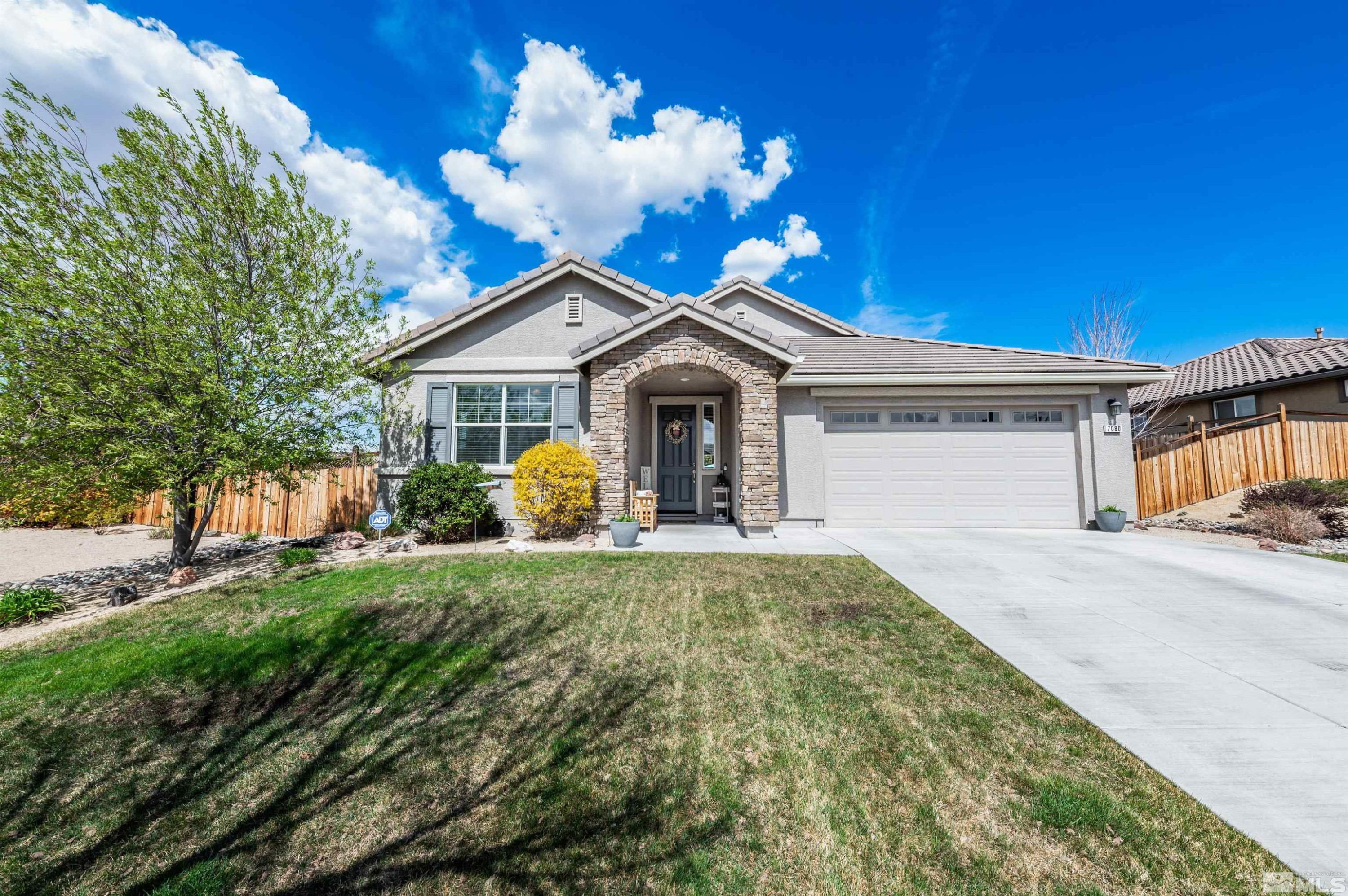 7080 Truth Drive Sparks, NV 89436 - Photo 4 of 40 a front view of a house with garden