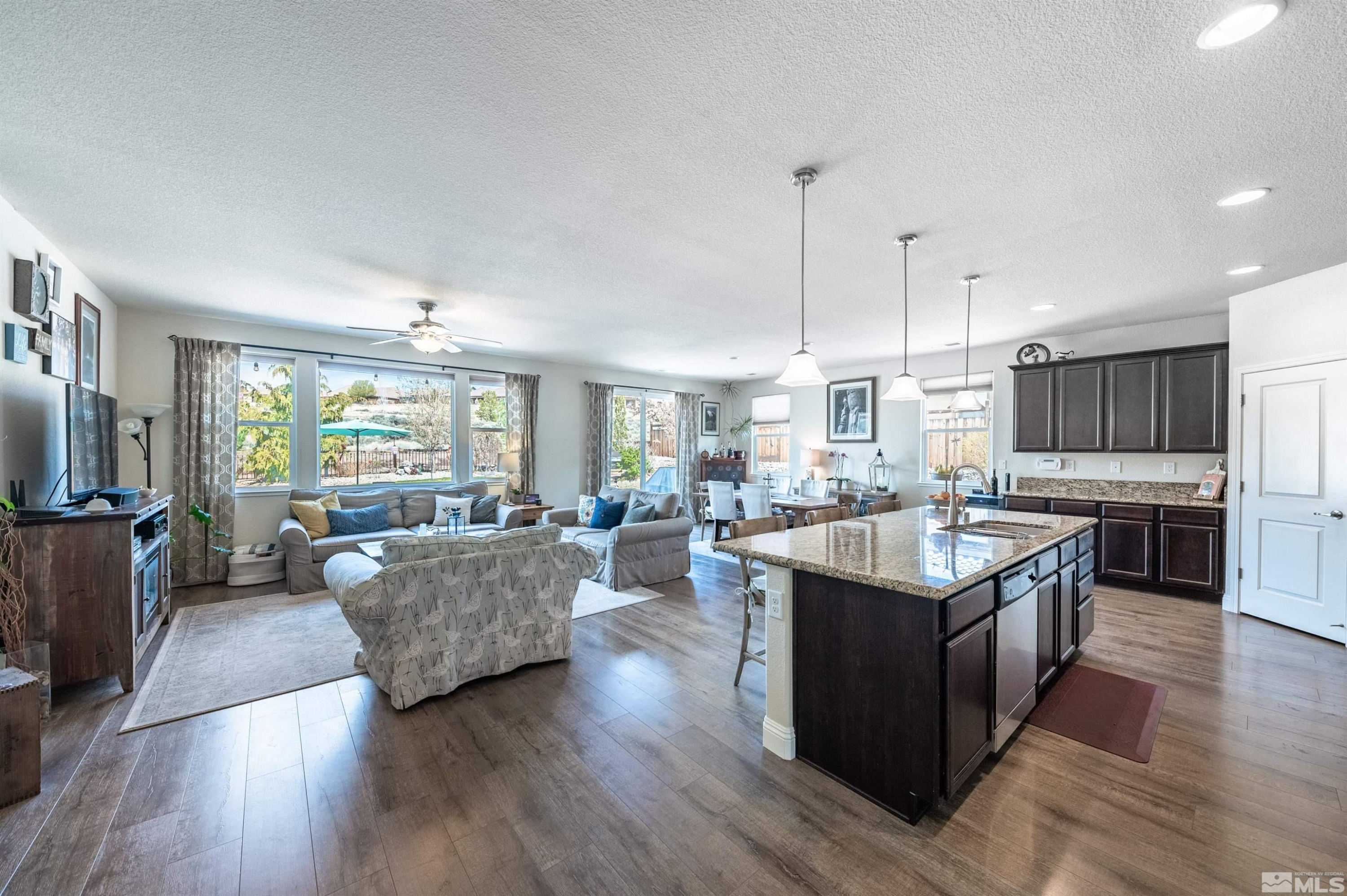 7080 Truth Drive Sparks, NV 89436 - Photo 7 of 40 a large kitchen with kitchen island a large counter space a sink and appliances