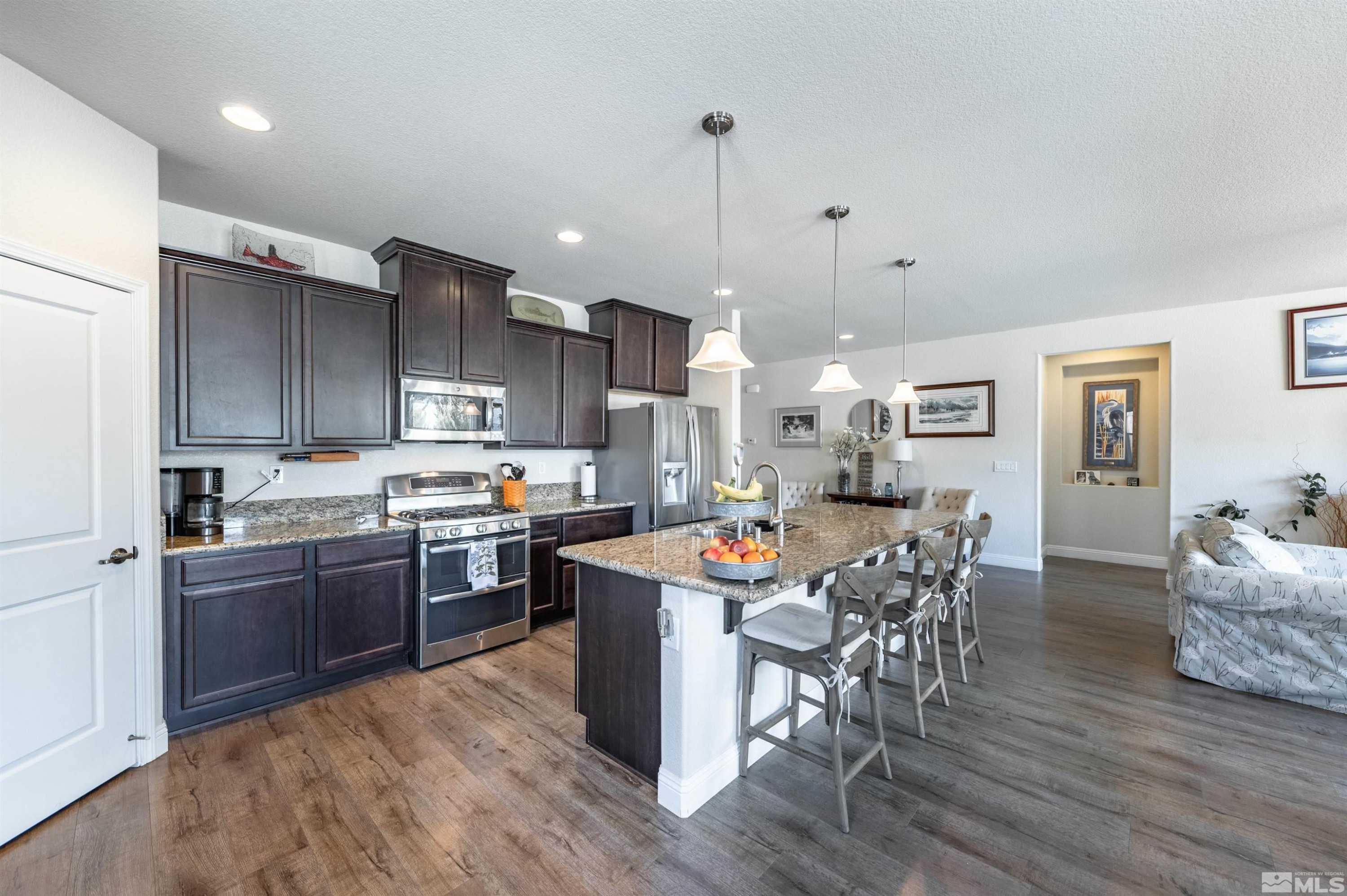 7080 Truth Drive Sparks, NV 89436 - Photo 9 of 40 a large kitchen with cabinets table and chairs