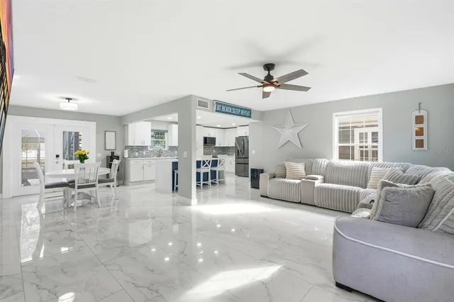 a kitchen with stainless steel appliances kitchen island granite countertop a kitchen island a stove a table and chairs