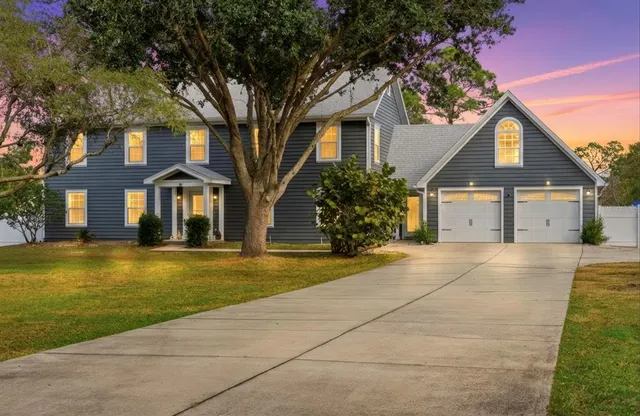a front view of a house with a garden