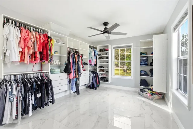 a bedroom with a bed a table and chair