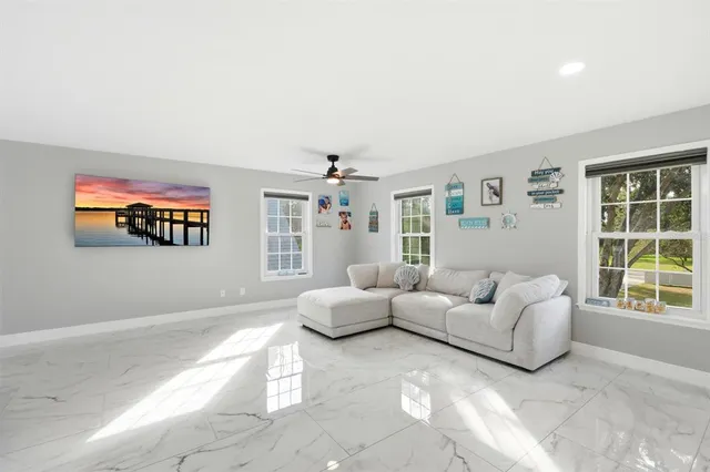 a living room with furniture gym equipment and a chandelier