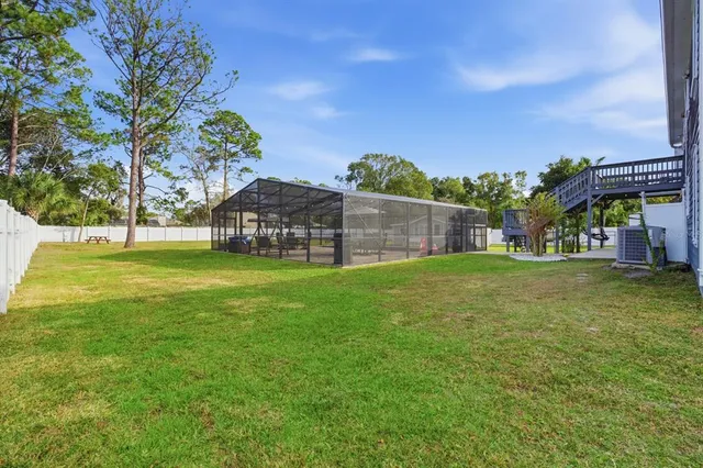 a aerial view of a house next to a yard