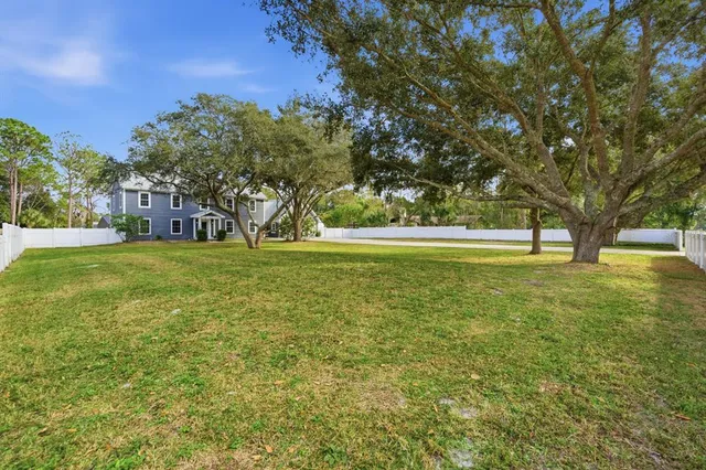 a view of a field with an trees