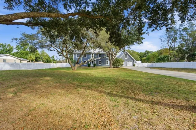 a view of a house with a yard and plants