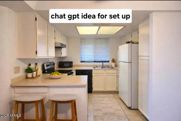 a kitchen with granite countertop white cabinets and white appliances