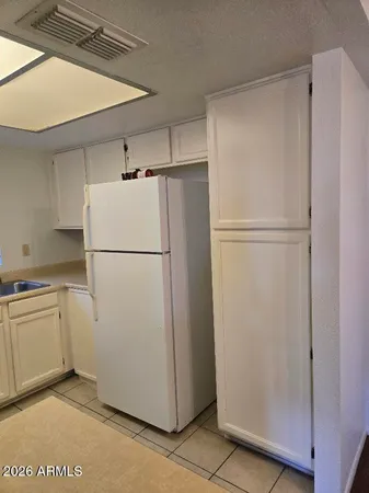 a bathroom with a granite countertop toilet and a sink