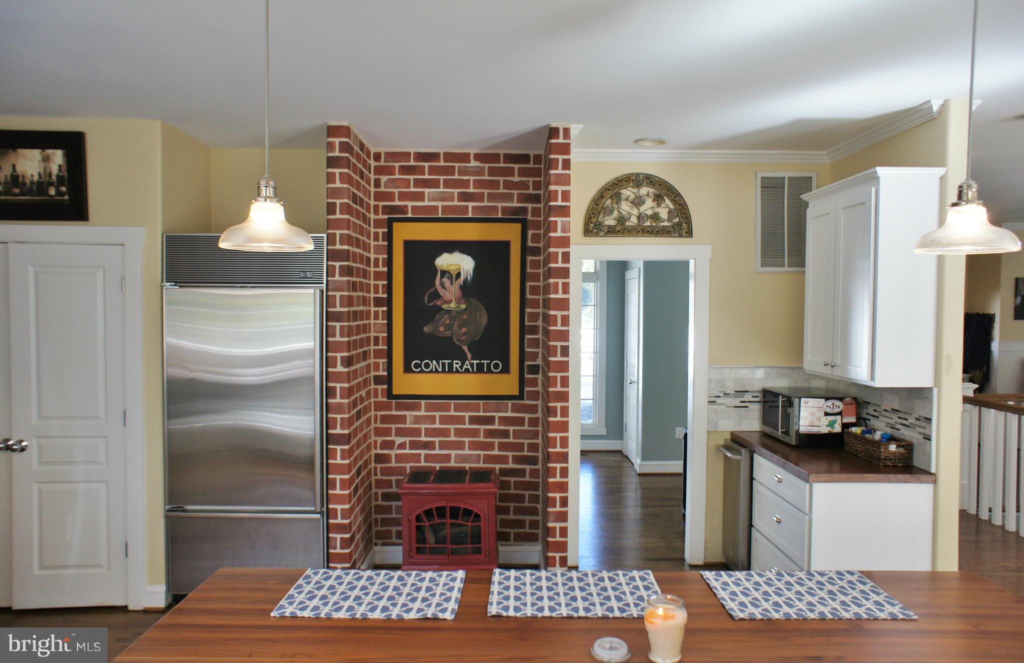 13292 Olivet Road Lusby, MD 20657 - Photo 4 of 30 Brick accent wall w/gas stove leads to office!