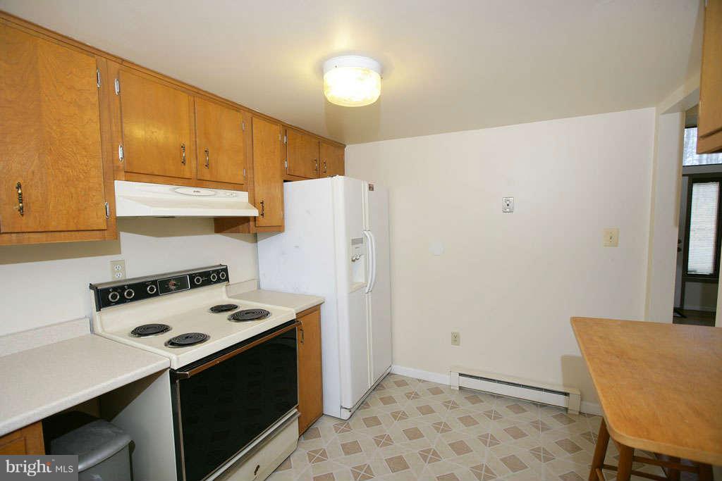 13217 Highland Road Highland, MD 20777 - Photo 14 of 23 a kitchen with a stove a refrigerator and a stove