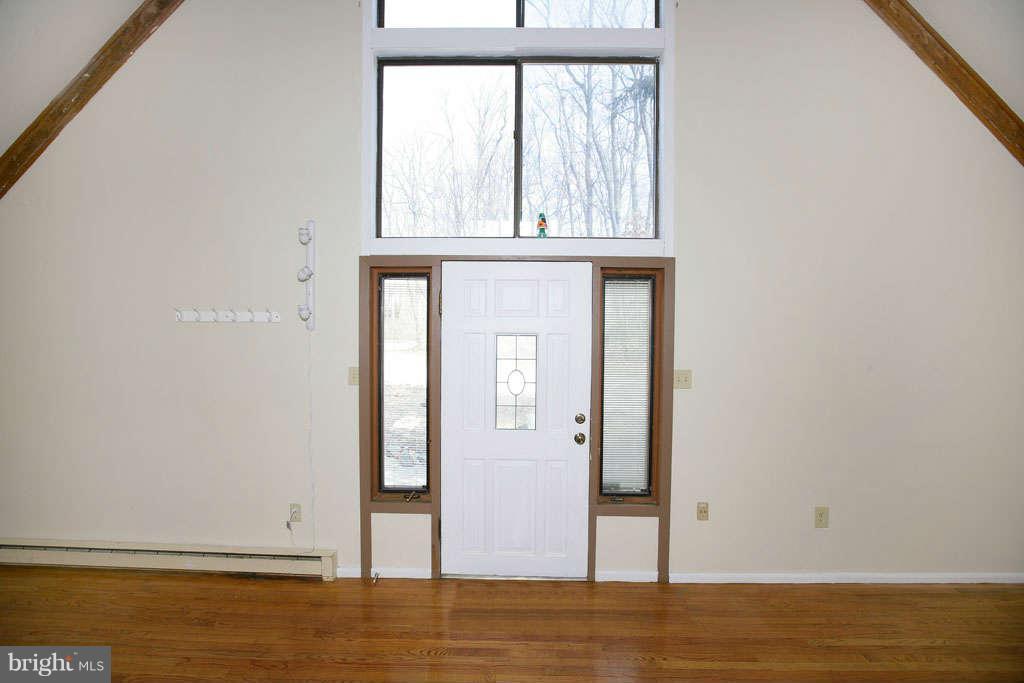 13217 Highland Road Highland, MD 20777 - Photo 7 of 23 a view of an empty room with wooden floor and a window