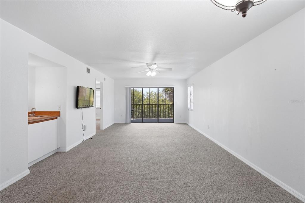175 Kings Highway, Unit 328 Punta Gorda, FL 33983 - Photo 11 of 41 a view of a livingroom with wooden floor and a window