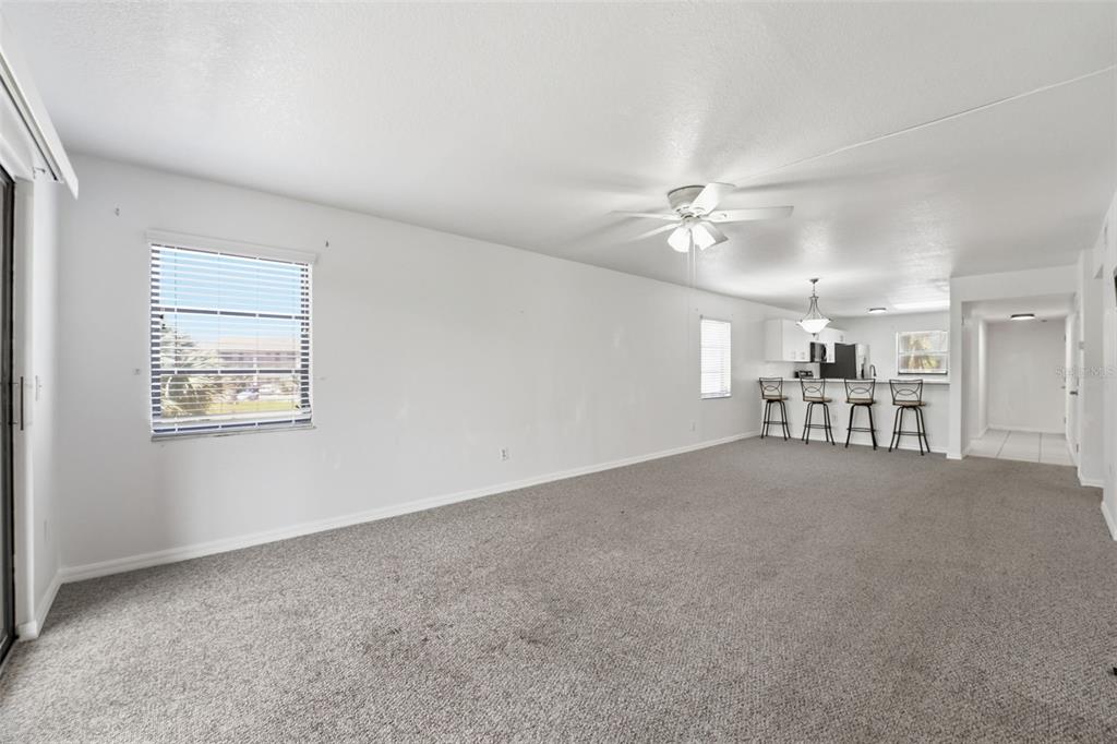 175 Kings Highway, Unit 328 Punta Gorda, FL 33983 - Photo 12 of 41 an empty room with chandelier fan and windows