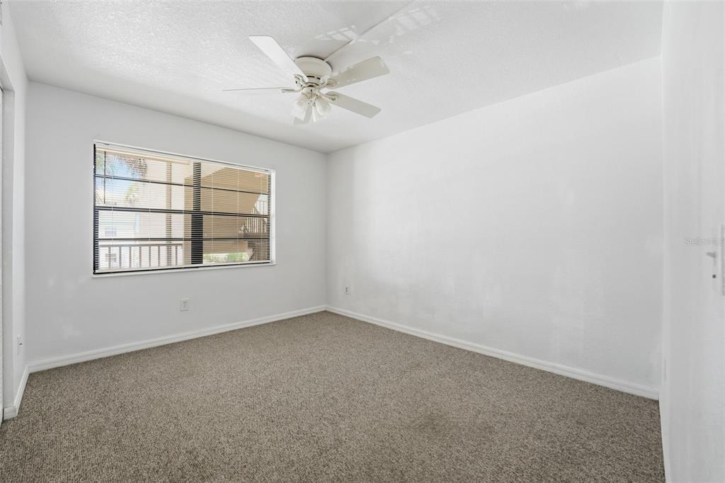 175 Kings Highway, Unit 328 Punta Gorda, FL 33983 - Photo 19 of 41 an empty room with windows and chandelier fan