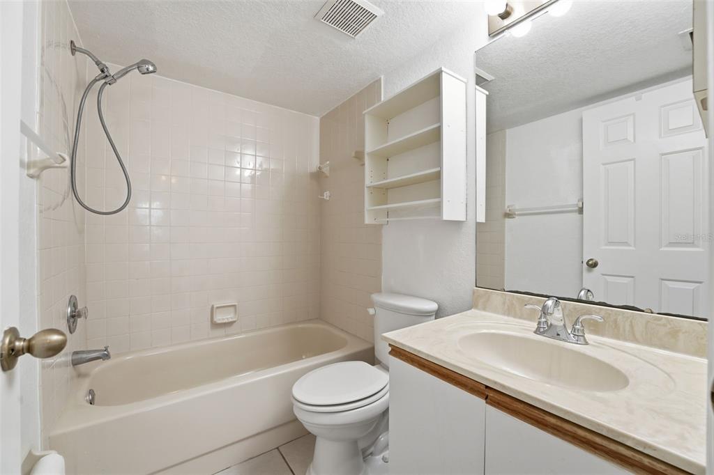 175 Kings Highway, Unit 328 Punta Gorda, FL 33983 - Photo 22 of 41 a bathroom with a granite countertop sink a toilet and a bathtub