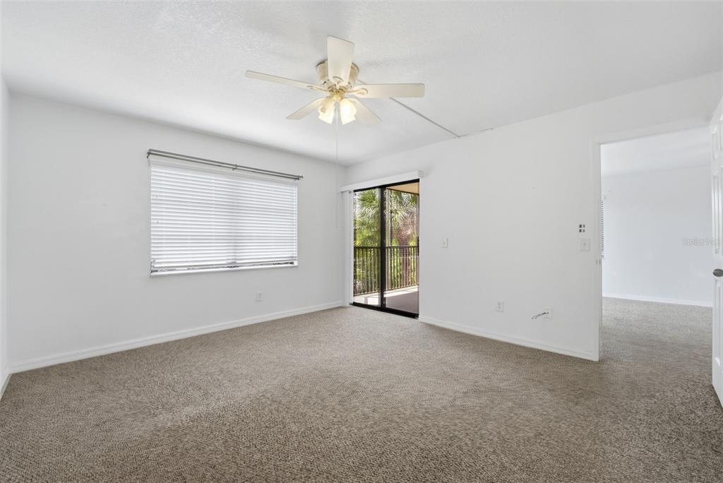 175 Kings Highway, Unit 328 Punta Gorda, FL 33983 - Photo 24 of 41 an empty room with chandelier fan and windows