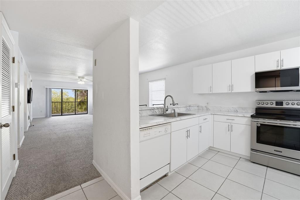 175 Kings Highway, Unit 328 Punta Gorda, FL 33983 - Photo 4 of 41 a kitchen with sink cabinets and appliances
