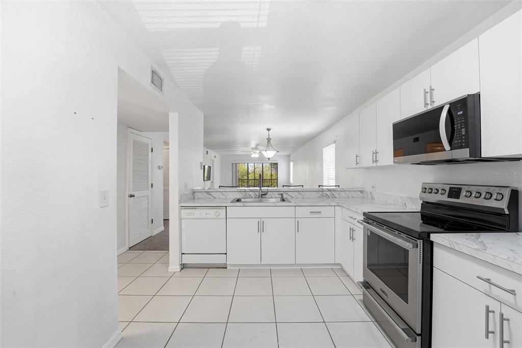 175 Kings Highway, Unit 328 Punta Gorda, FL 33983 - Photo 8 of 41 a kitchen with a sink stove and microwave